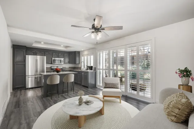 a living room with furniture and a dining table with kitchen view