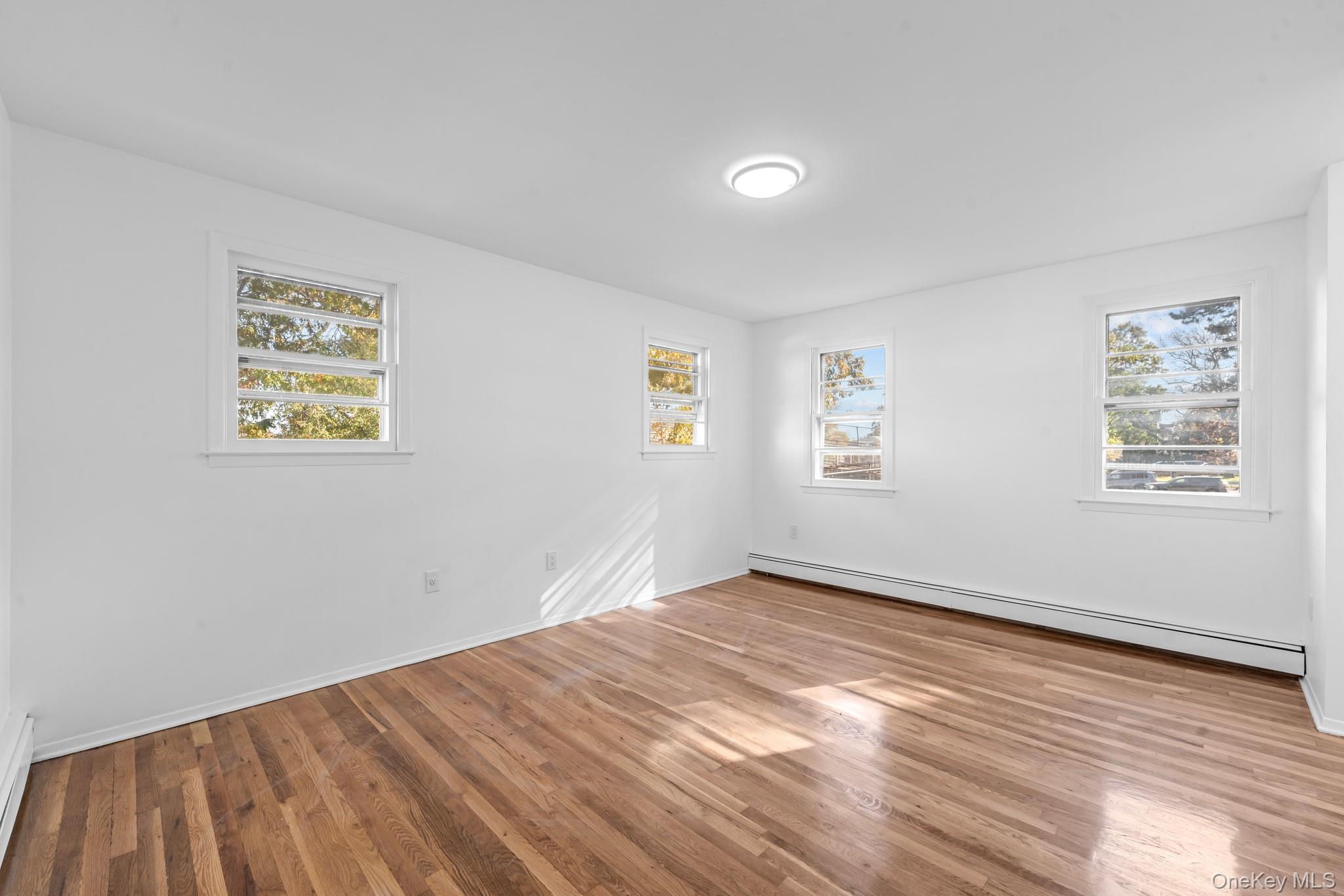 172-11 Horace Harding Expressway Queens, NY 11365 - Photo 11 of 17 a view of empty room with wooden floor