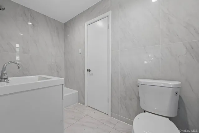 a bathroom with a toilet sink and shower