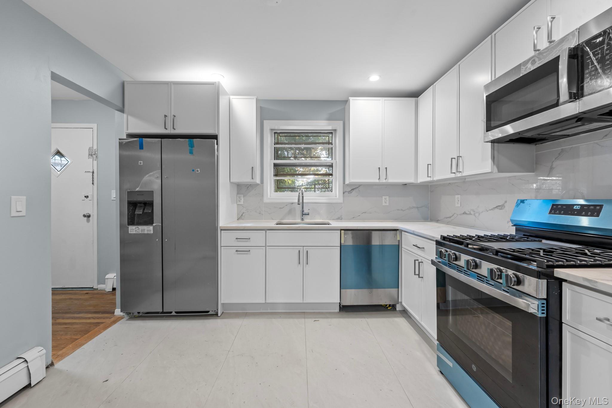 172-11 Horace Harding Expressway Queens, NY 11365 - Photo 2 of 17 a kitchen with stainless steel appliances granite countertop a stove a refrigerator and a sink