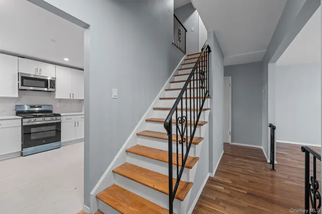 a view of a kitchen with wooden floor and electronic appliances