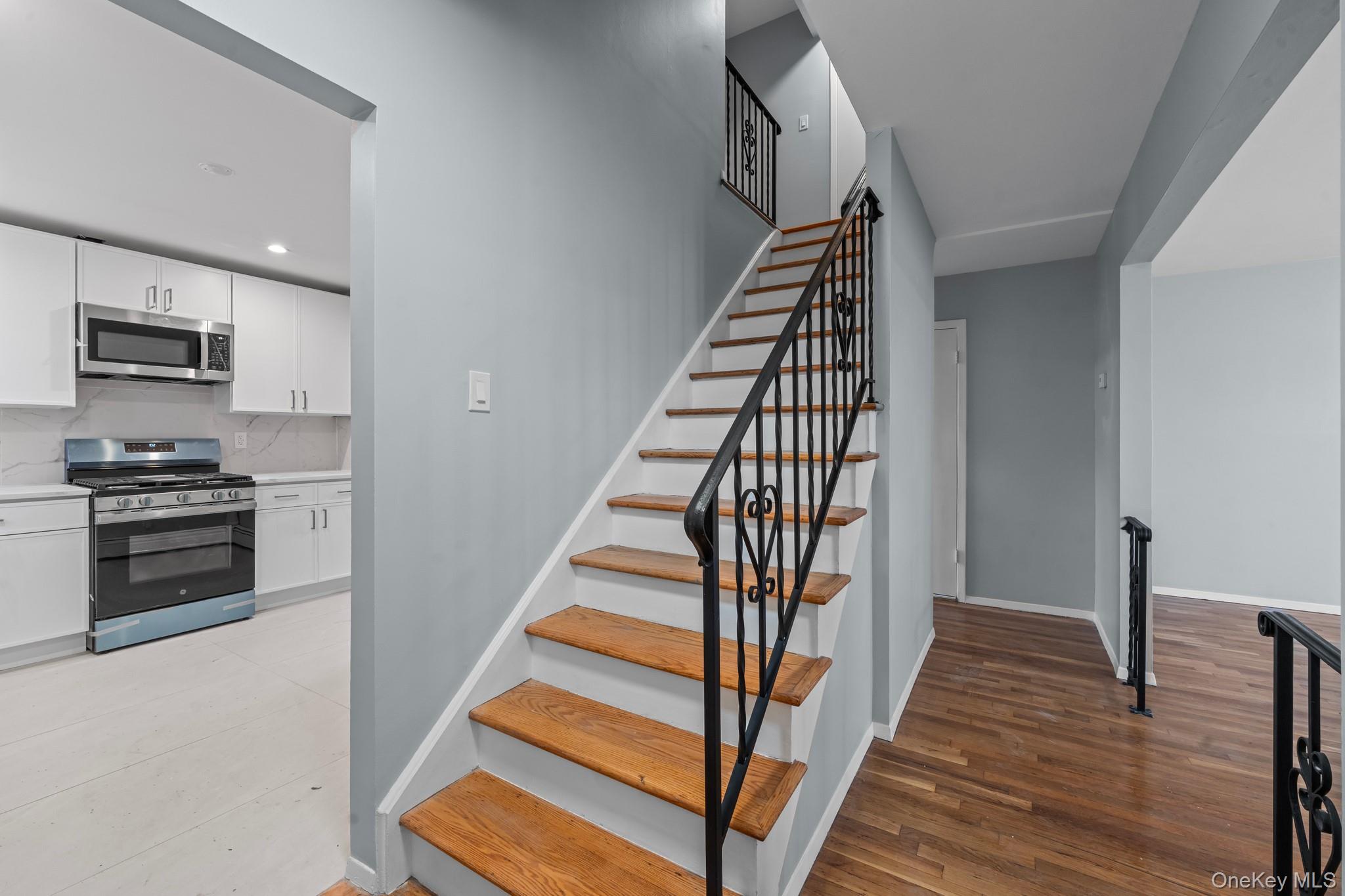 172-11 Horace Harding Expressway Queens, NY 11365 - Photo 10 of 17 a view of a kitchen with wooden floor and electronic appliances