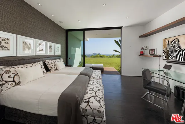 a bed room with a bed and a television