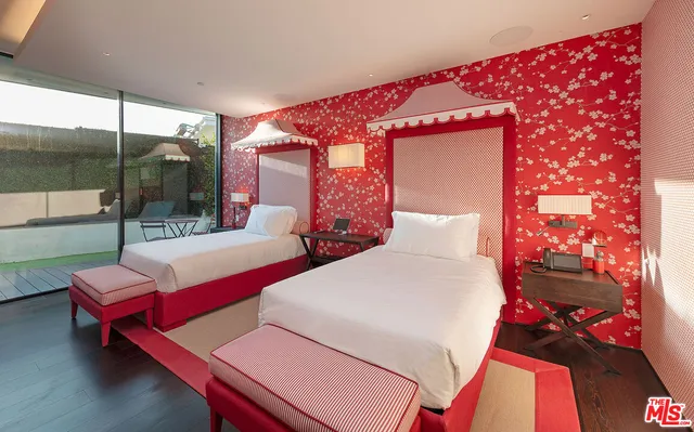 a view of a patio with table and chairs potted plants and floor to ceiling window