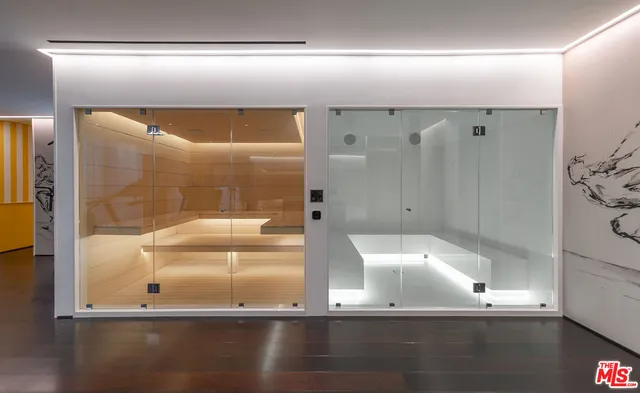 a kitchen with stainless steel appliances granite countertop a refrigerator a stove and a wooden floors