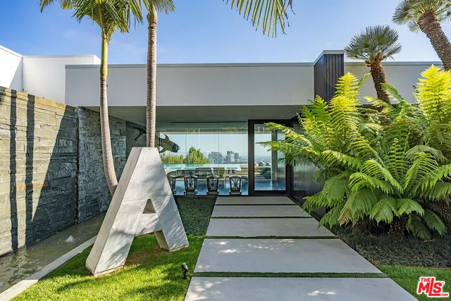 an outdoor sitting area with furniture and city view