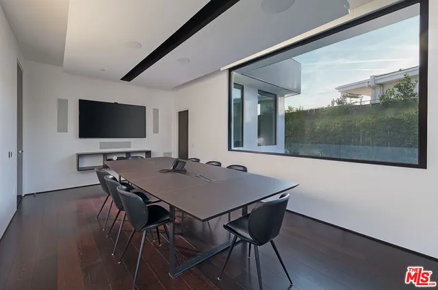 a room with stainless steel appliances kitchen island granite countertop a dining table and chairs