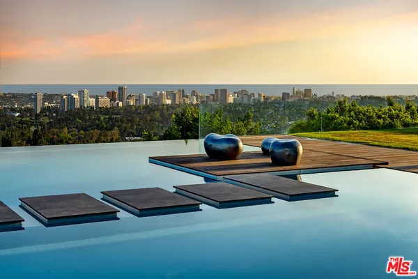 a roof deck with couches and wooden floor