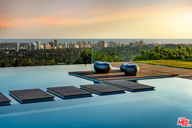 a roof deck with couches and wooden floor