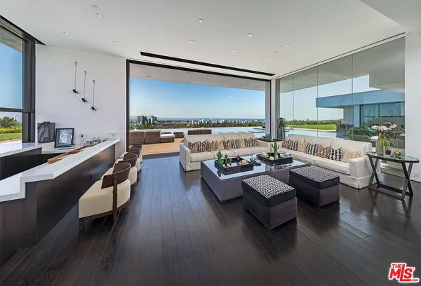 a dining table chairs in front of a room