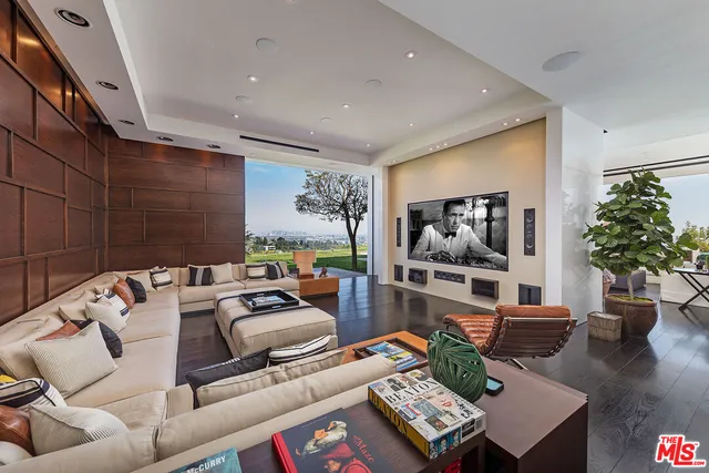 a bedroom with a bed and large windows