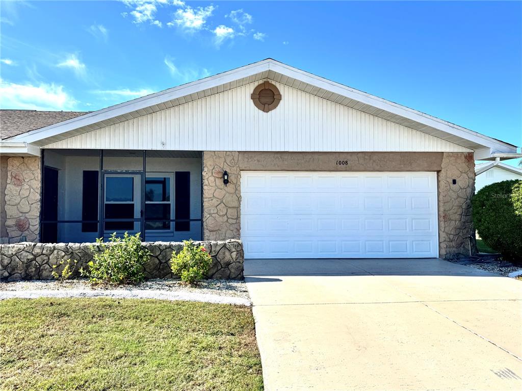 1008 Yellowbird Place Sun City Center, FL 33573 - Photo 1 of 2 a front view of a house with a yard