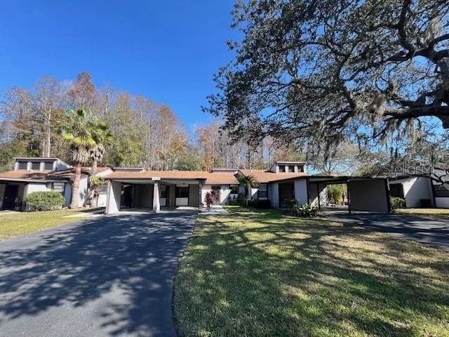 a view of a house with pool and sitting area