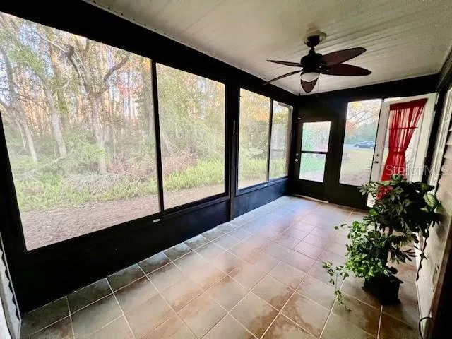 an aerial view of a house with a yard and lake view