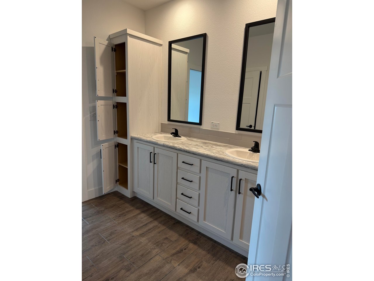 45881 County Road 35 Pierce, CO 80650 - Photo 16 of 47 a spacious bathroom with a double vanity sink and a mirror
