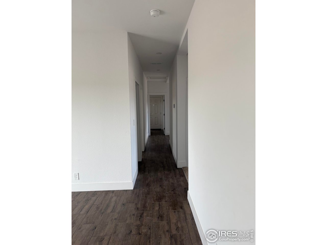 45881 County Road 35 Pierce, CO 80650 - Photo 17 of 47 a view of a hallway with wooden floor
