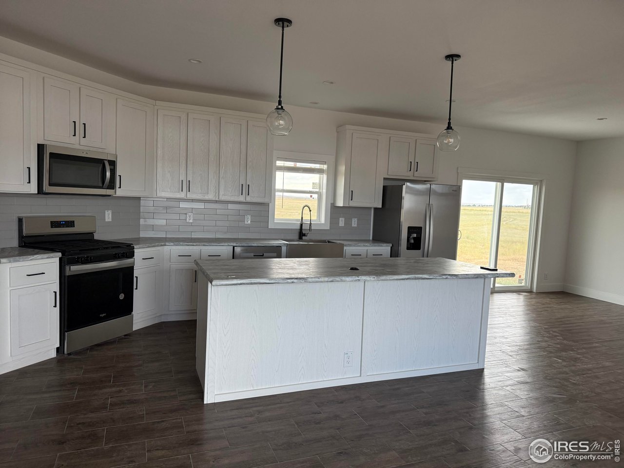 45881 County Road 35 Pierce, CO 80650 - Photo 3 of 47 a kitchen with stainless steel appliances granite countertop a sink a stove a refrigerator and cabinets