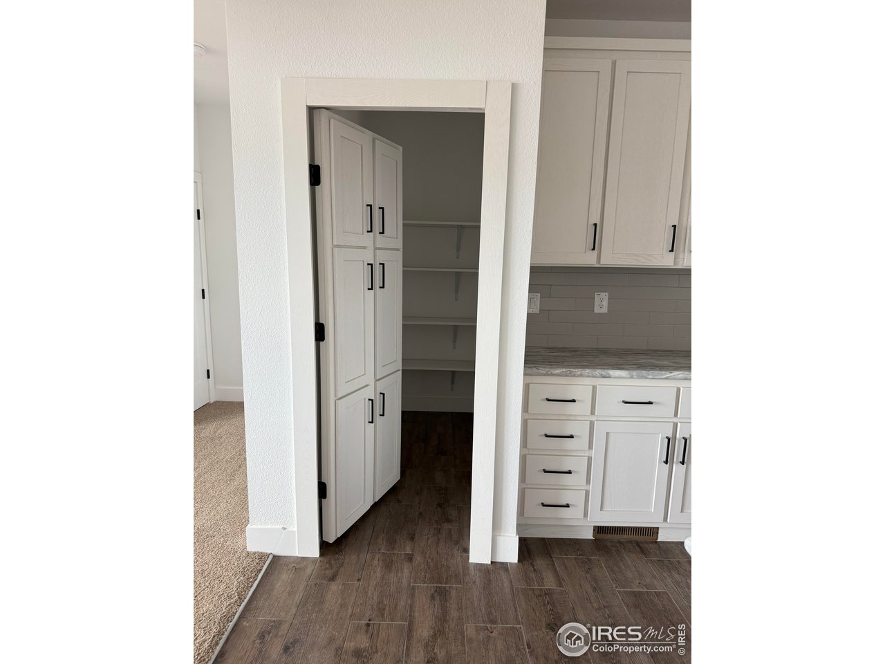 45881 County Road 35 Pierce, CO 80650 - Photo 4 of 47 a view of cabinets and wooden floor