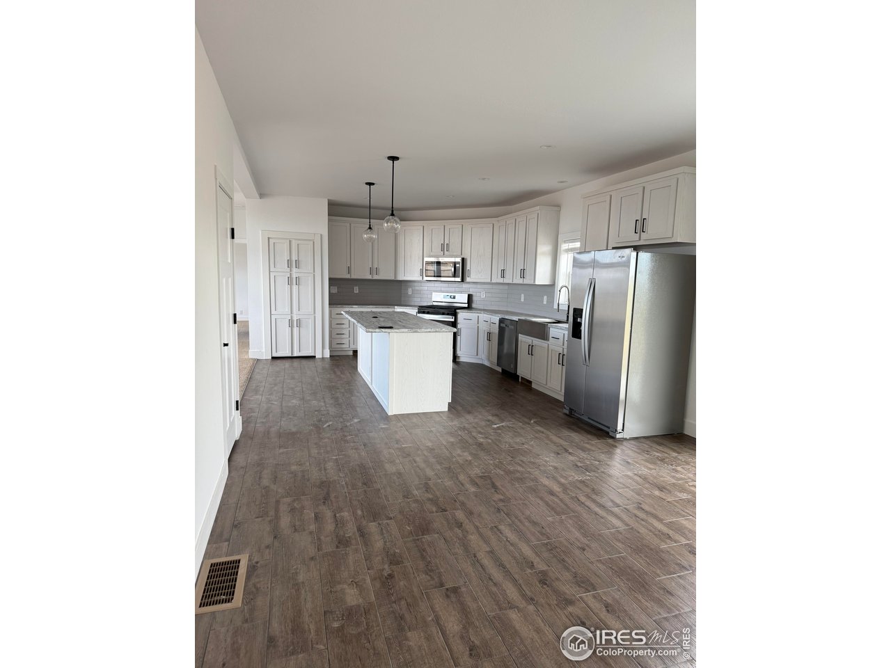 45881 County Road 35 Pierce, CO 80650 - Photo 8 of 47 a kitchen with refrigerator and cabinets