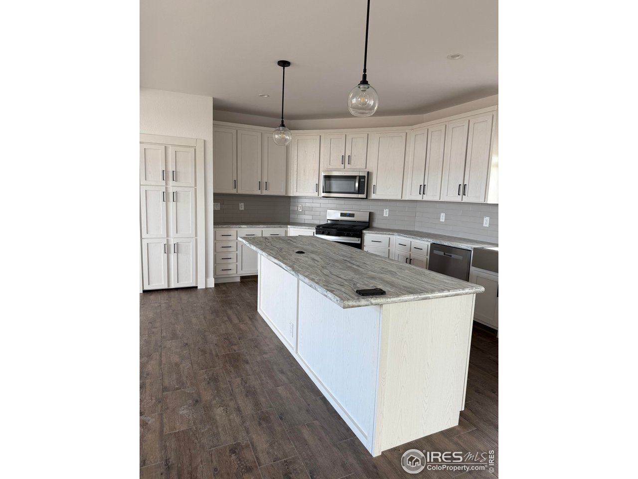 45881 County Road 35 Pierce, CO 80650 - Photo 9 of 47 a kitchen with kitchen island sink stove and cabinets