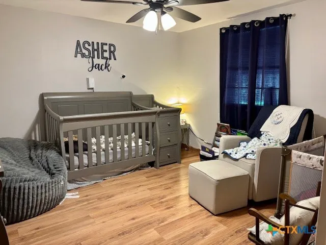 a bedroom with furniture and wooden floor