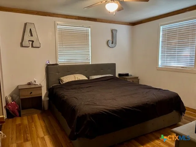 a bedroom with a bed and a chandelier