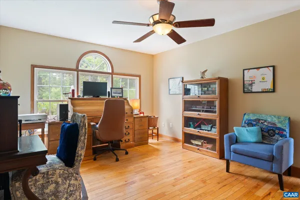 a spacious bedroom with a bed window and a flat tv screen