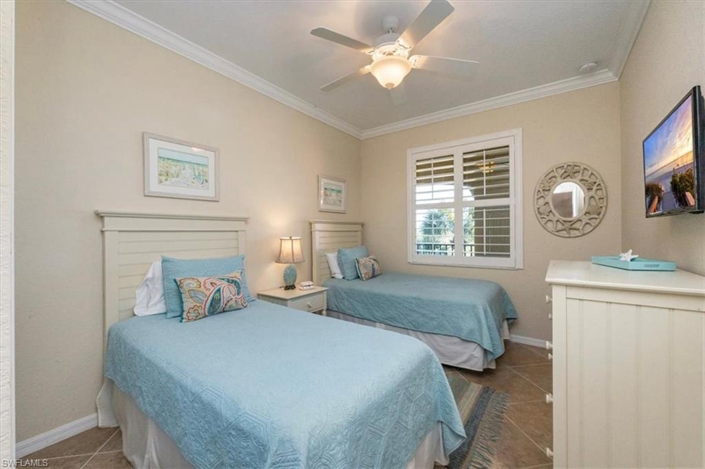 9566 Trevi Court, Unit 4942 Naples, FL 34113 - Photo 16 of 31 a bedroom with two beds and a window