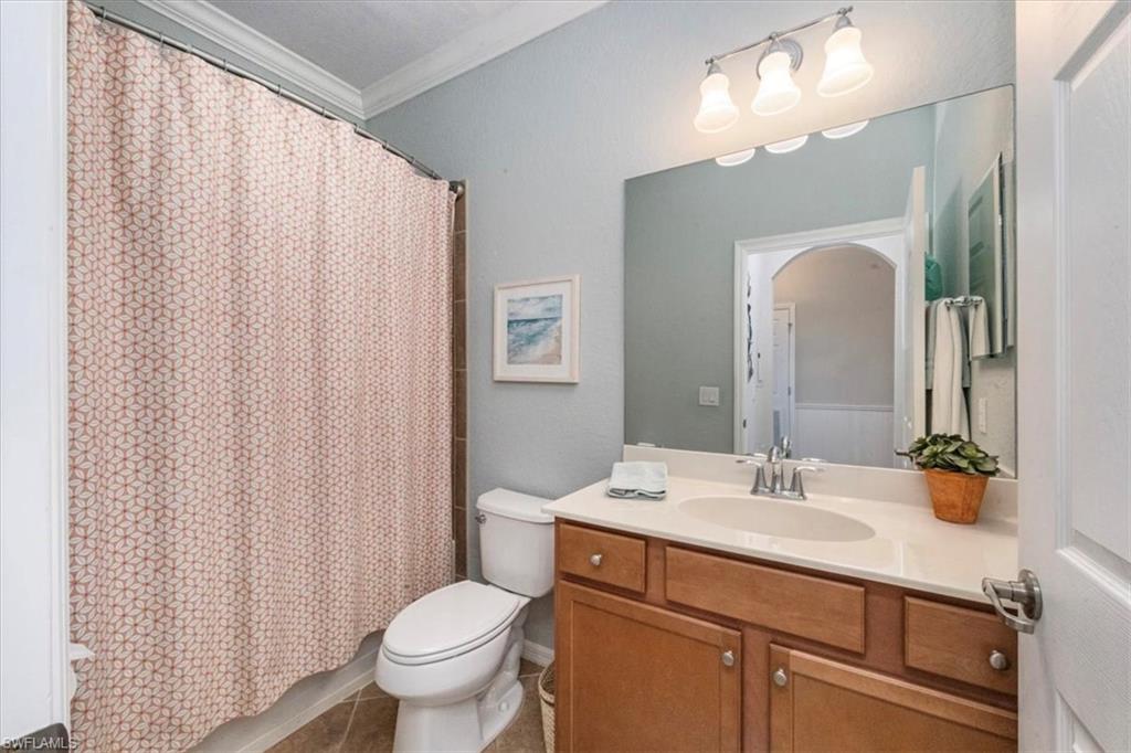 9566 Trevi Court, Unit 4942 Naples, FL 34113 - Photo 18 of 31 a bathroom with a sink a toilet and a mirror