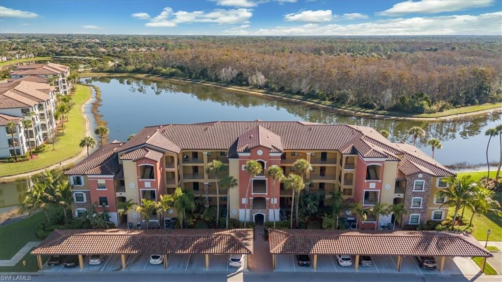 9566 Trevi Court, Unit 4942 Naples, FL 34113 - Photo 23 of 31 a view of house with yard and ocean view