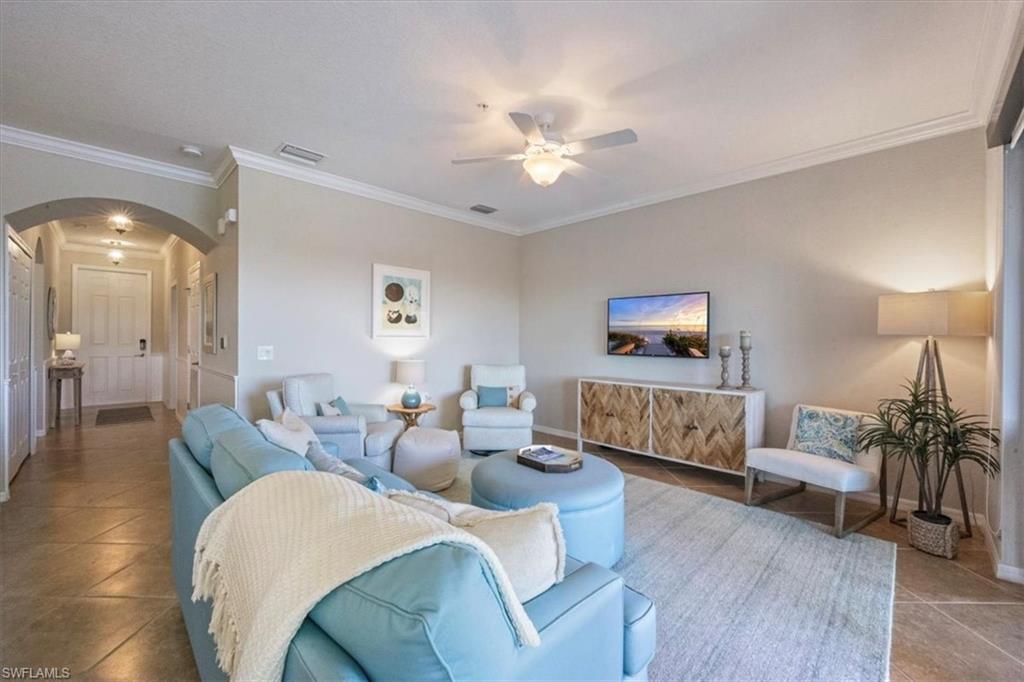9566 Trevi Court, Unit 4942 Naples, FL 34113 - Photo 3 of 31 a living room with furniture and wooden floor