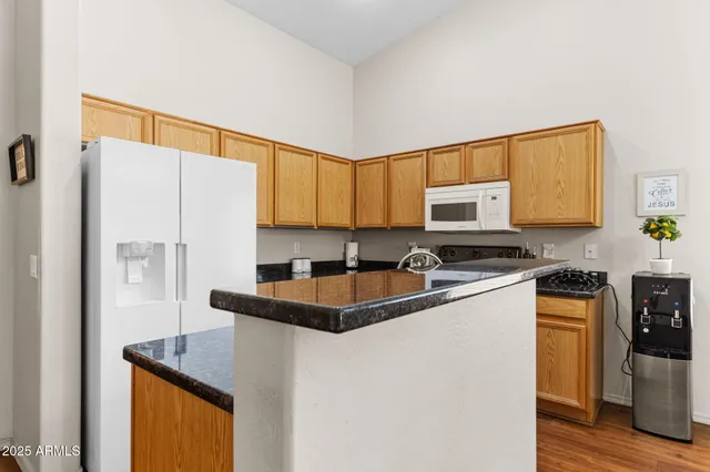 a kitchen with stainless steel appliances a refrigerator a sink a stove a microwave and island
