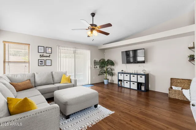 a living room with furniture wooden floor and window