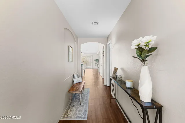 a hallway with painting and wooden floor