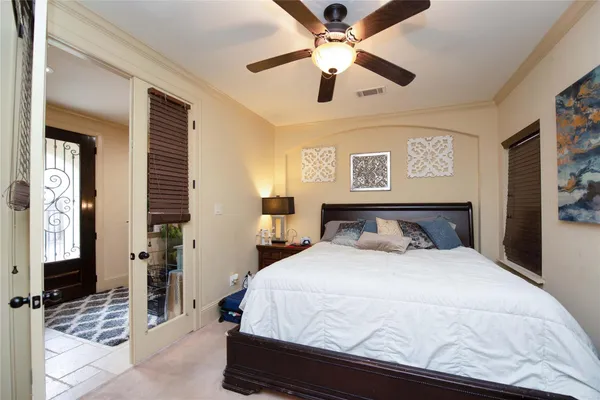 a bedroom with a large bed and a chandelier