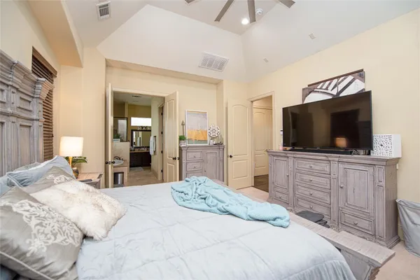 a bedroom with a flat screen television and a bed