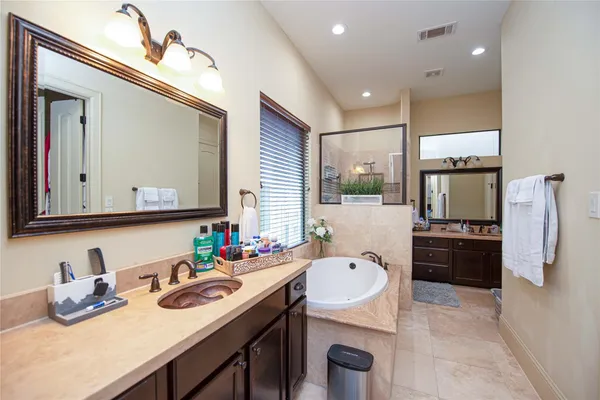 a kitchen with stainless steel appliances granite countertop a sink refrigerator and cabinets