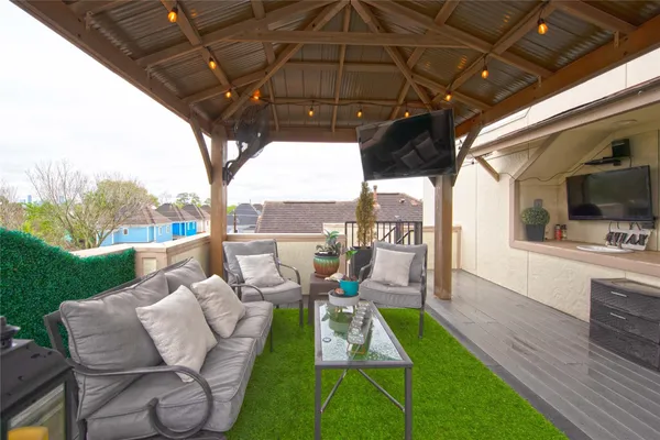 a view of yard from deck with patio