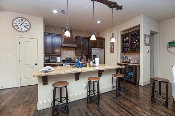 a kitchen with a sink cabinets and wooden floor
