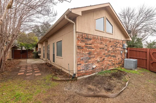 a view of a wooden house with a yard