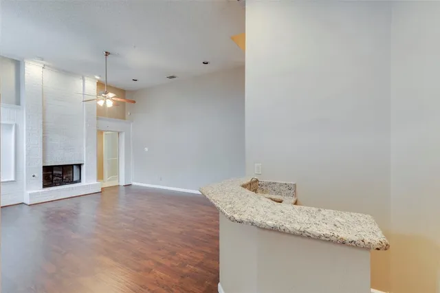 a view of a kitchen with a sink and a fireplace