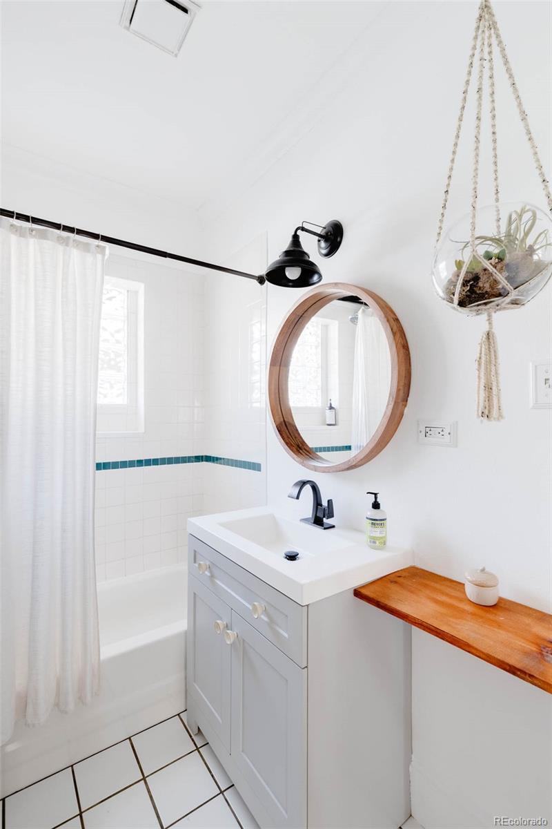 1058 Jackson Street Denver, CO 80206 - Photo 13 of 24 a bathroom with a sink mirror vanity and toilet