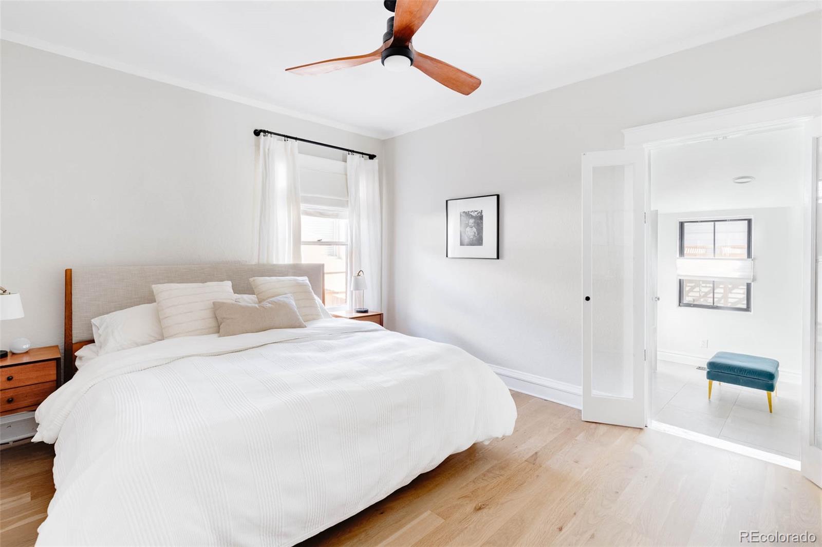 1058 Jackson Street Denver, CO 80206 - Photo 14 of 24 a bedroom with a bed and a painting on the wall