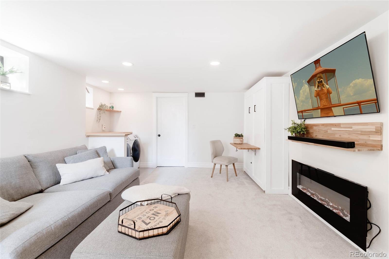 1058 Jackson Street Denver, CO 80206 - Photo 19 of 24 a living room with furniture and a flat screen tv