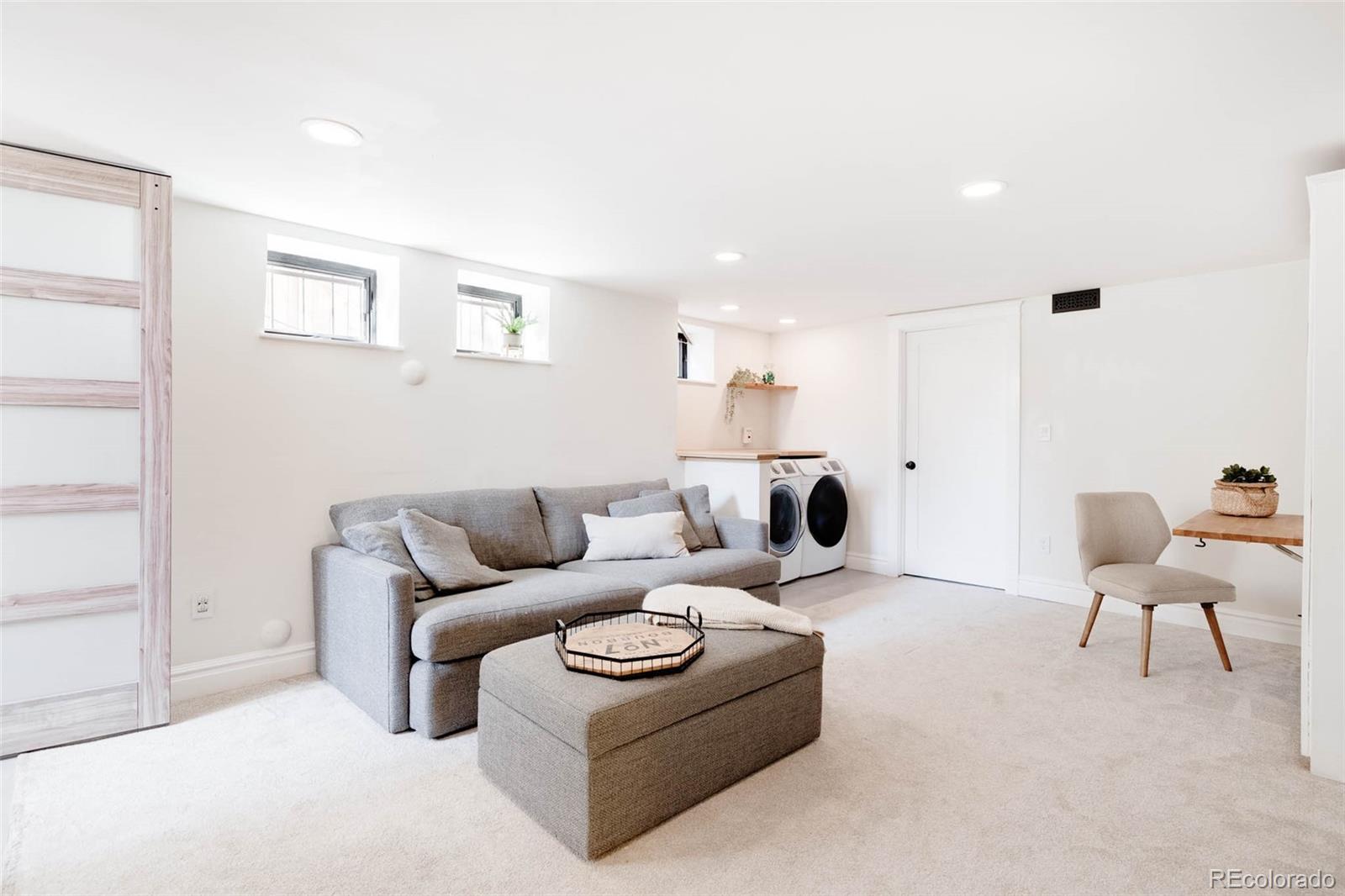 1058 Jackson Street Denver, CO 80206 - Photo 20 of 24 a living room with furniture and a chandelier