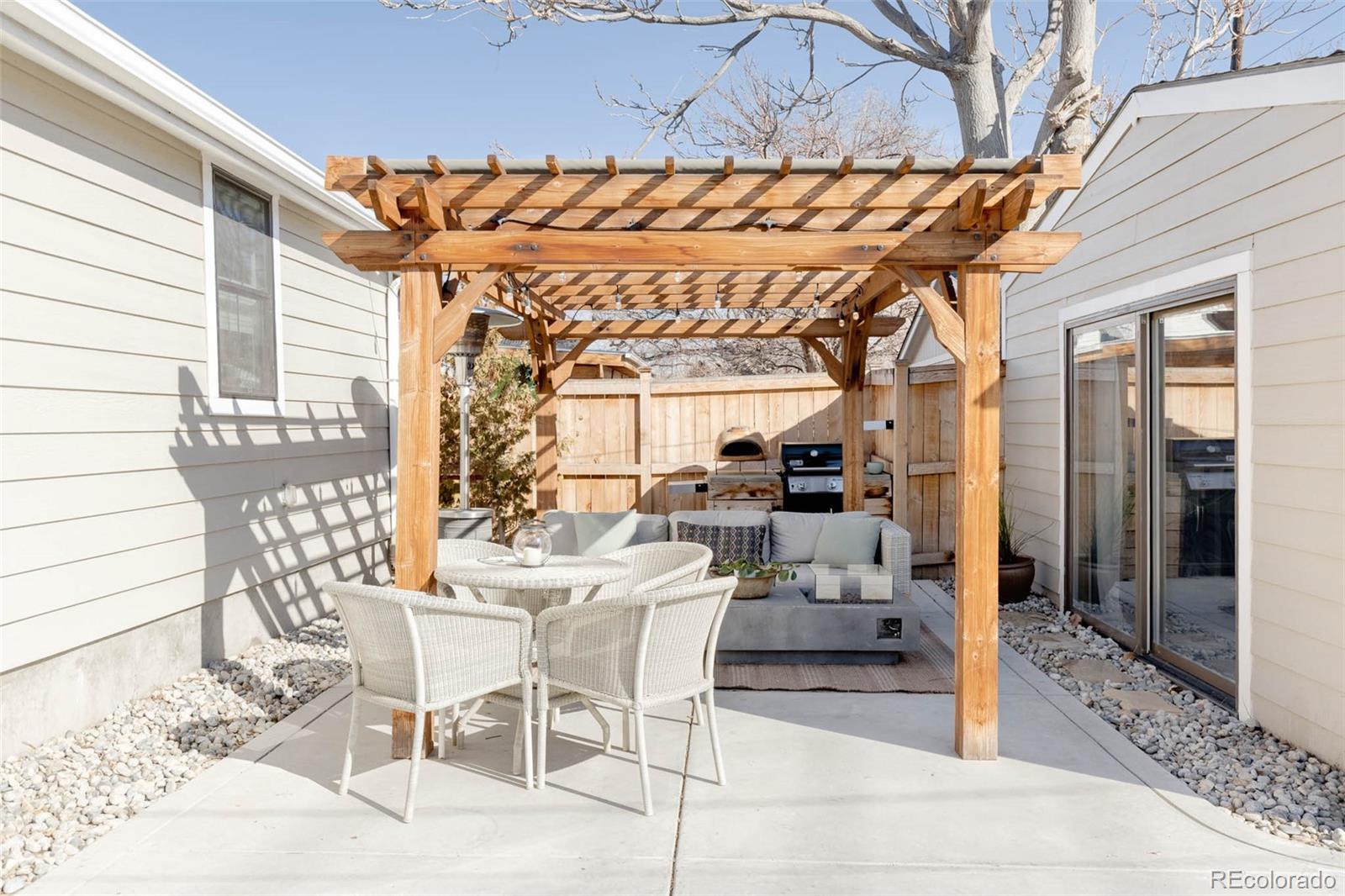 1058 Jackson Street Denver, CO 80206 - Photo 22 of 24 a view of a patio with a table and chairs and potted plants