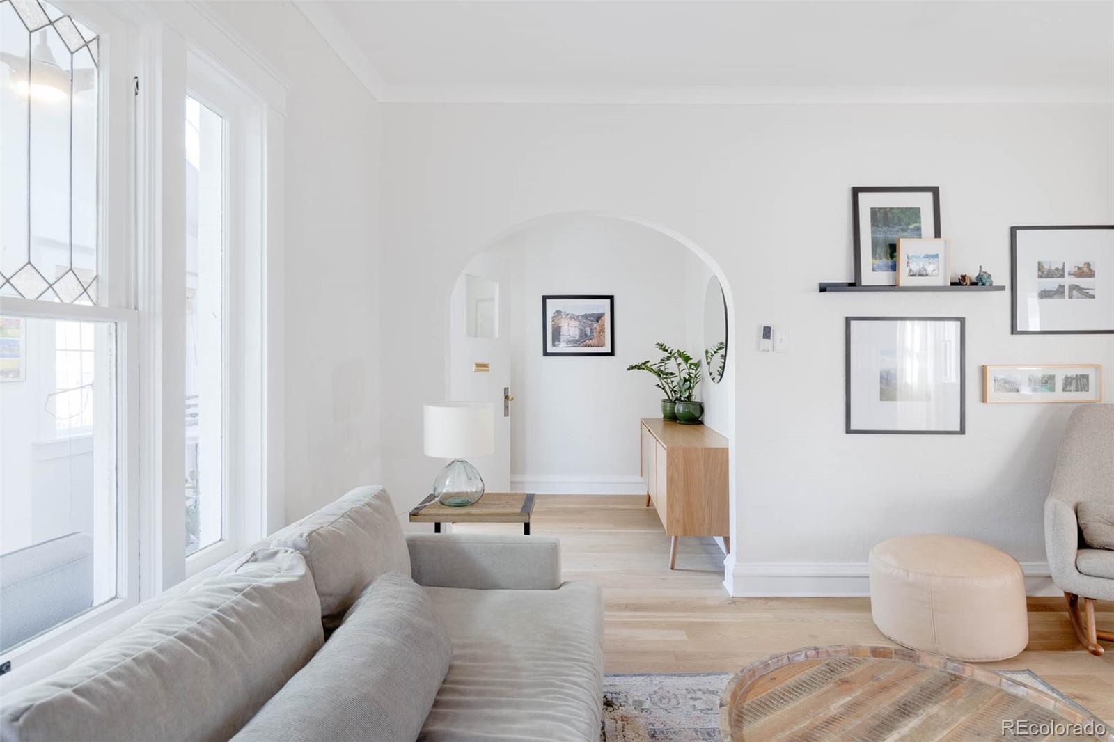 1058 Jackson Street Denver, CO 80206 - Photo 4 of 24 a living room with furniture and a window