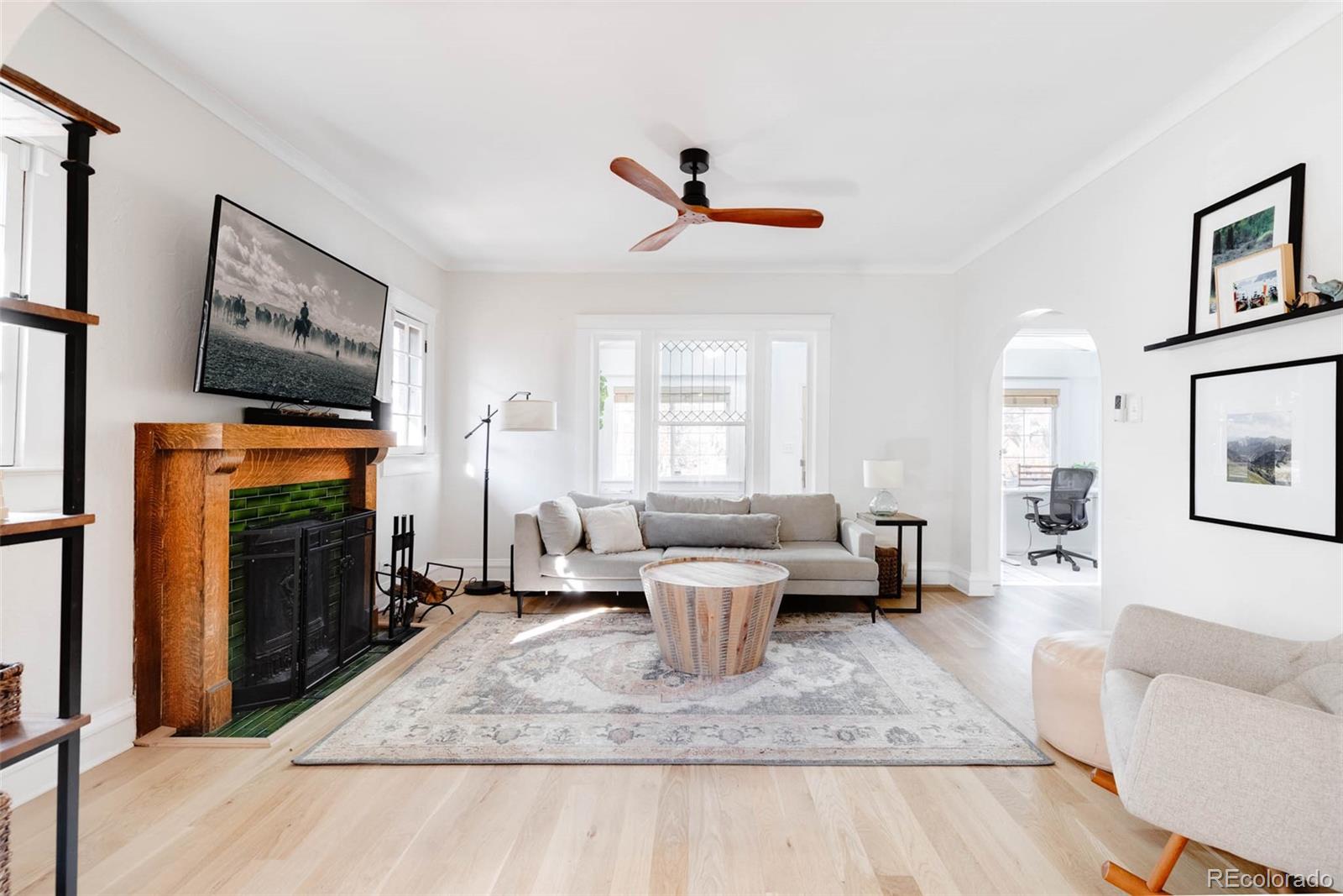 1058 Jackson Street Denver, CO 80206 - Photo 6 of 24 a living room with fireplace furniture and a flat screen tv