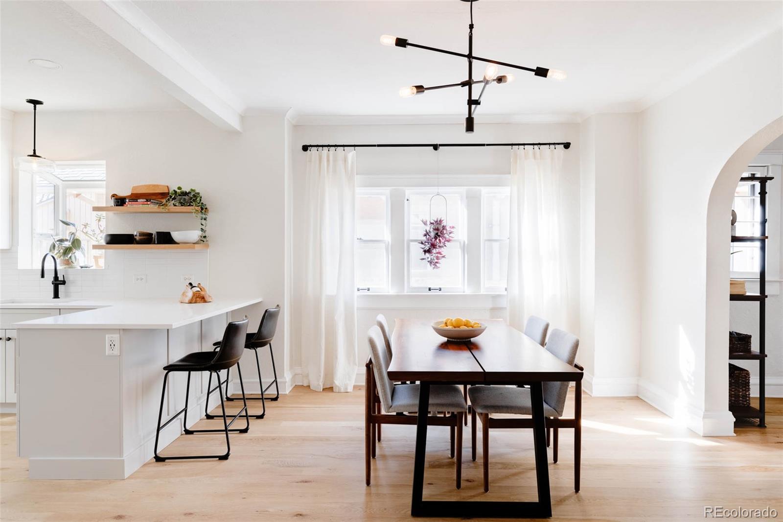 1058 Jackson Street Denver, CO 80206 - Photo 8 of 24 a view of a dining room with furniture and wooden floor