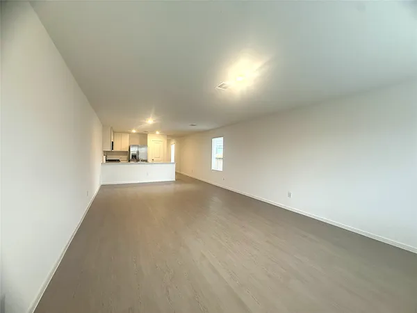 an empty room with entrance and windows